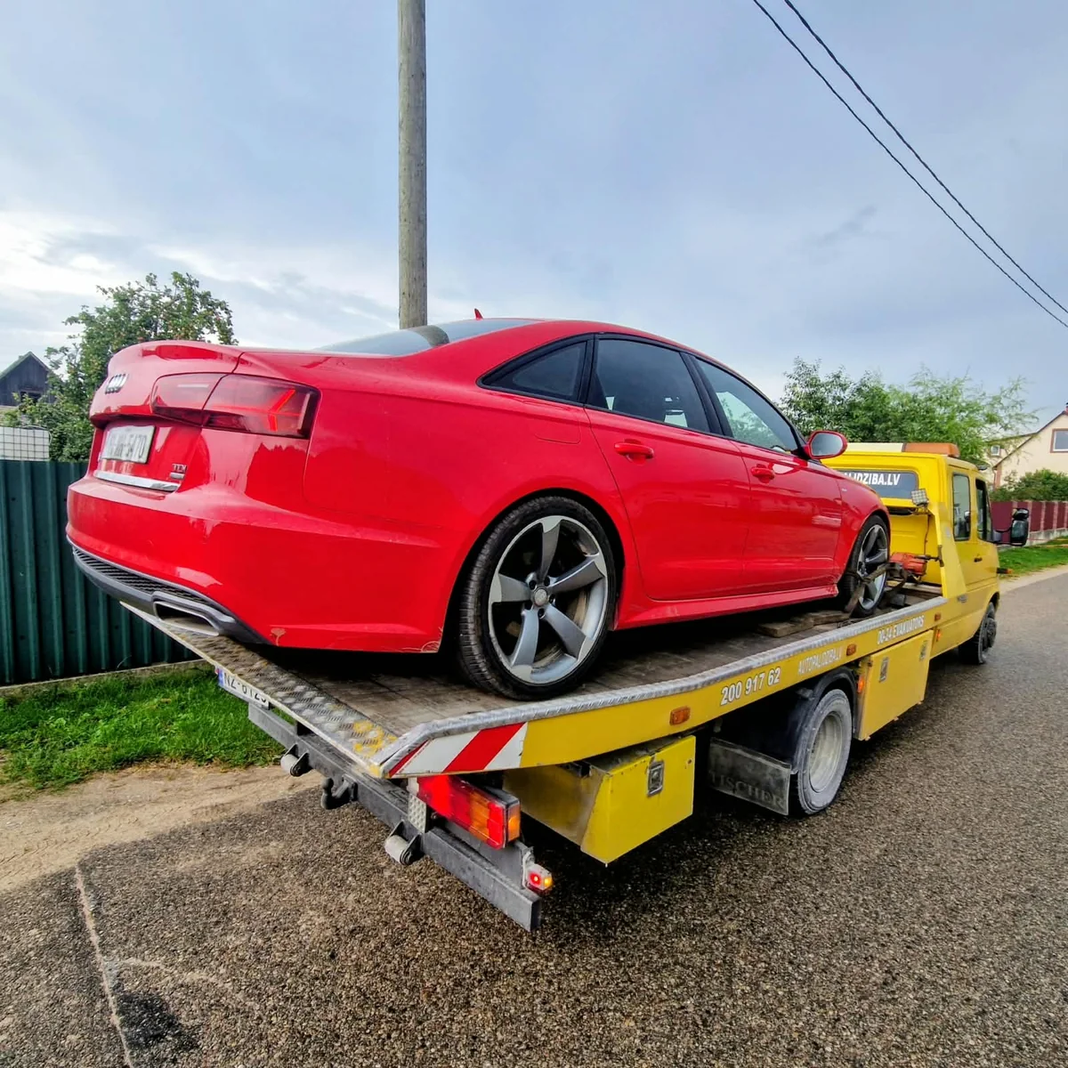 Tow truck transporting a passenger car